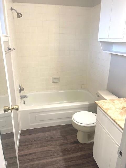 Bathroom featuring wood finished floors, toilet, 