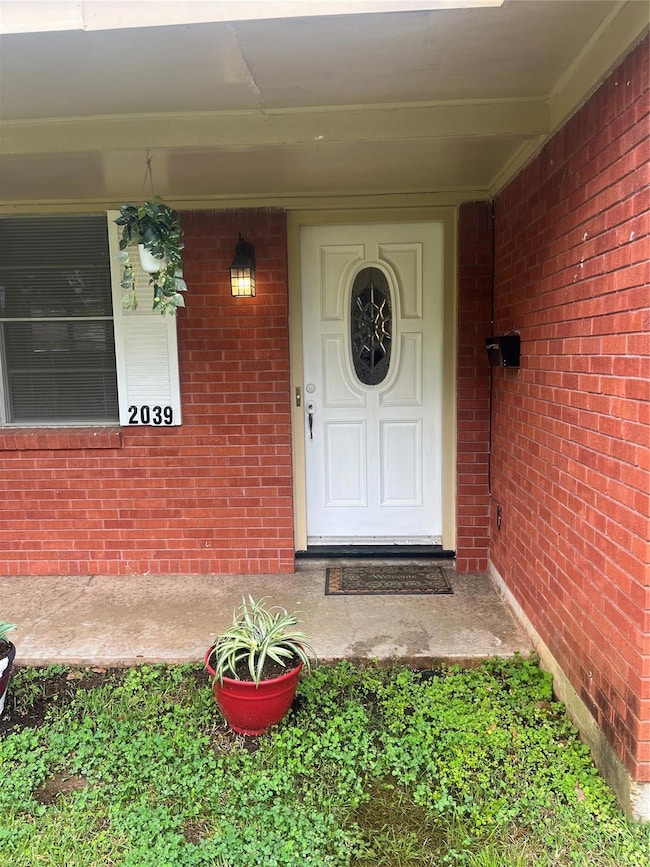 Property entrance with brick siding
