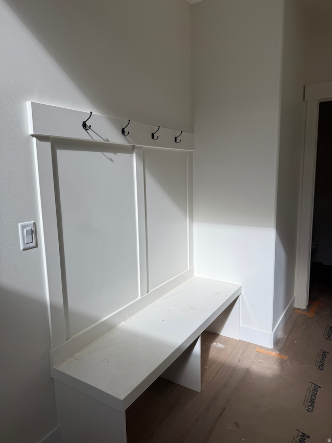 Mudroom with wood finished floors and baseboards