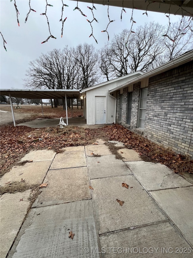 View of property exterior with brick siding and a