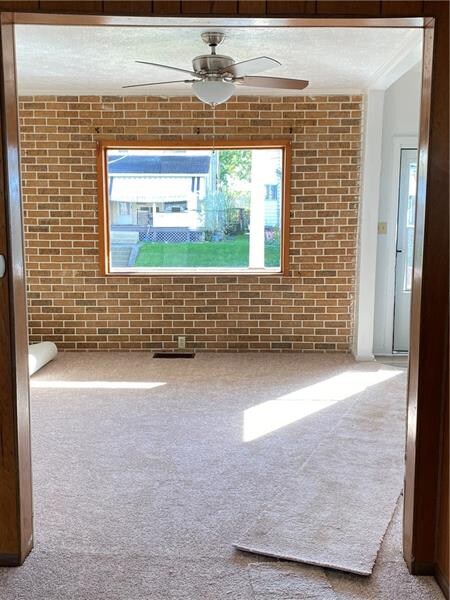 LR with brick-look accent wall & large window for 