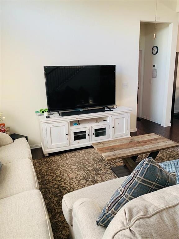 Living room featuring dark wood-style flooring