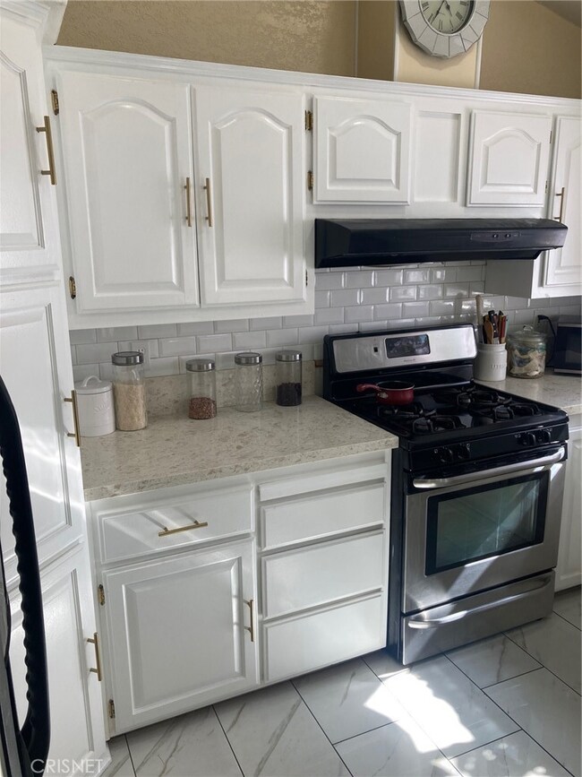 Freshly painted cupboards, new backsplash, and new handles complete this great kitchen