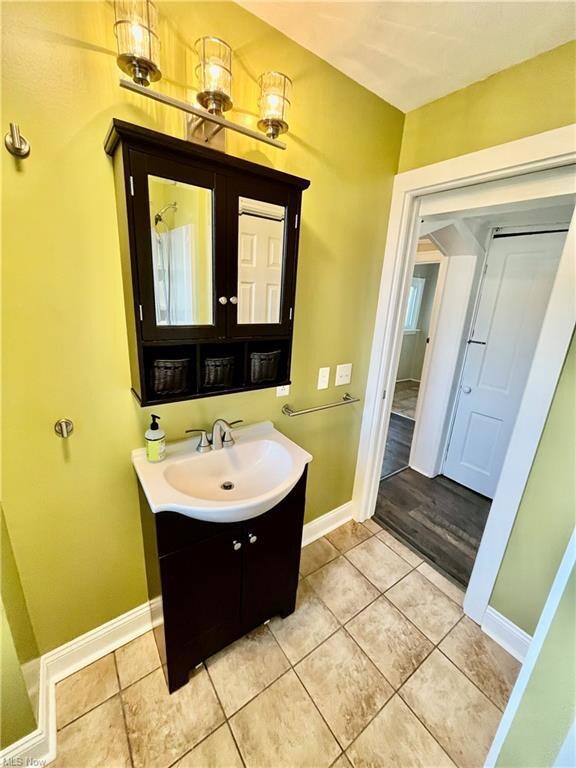 Bathroom with hardwood flooring and large vanity