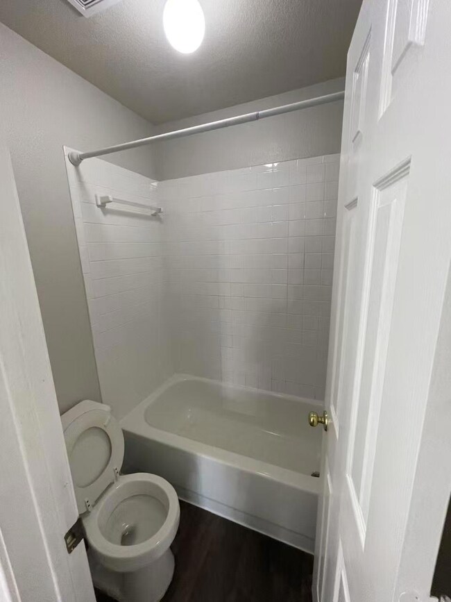 Bathroom featuring a textured ceiling, wood finis