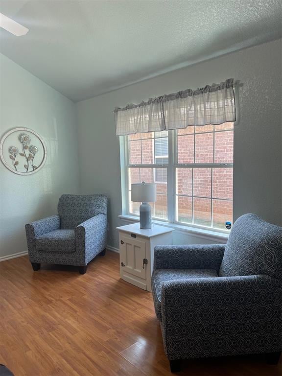 Sitting room with light wood-type flooring and baseboards
