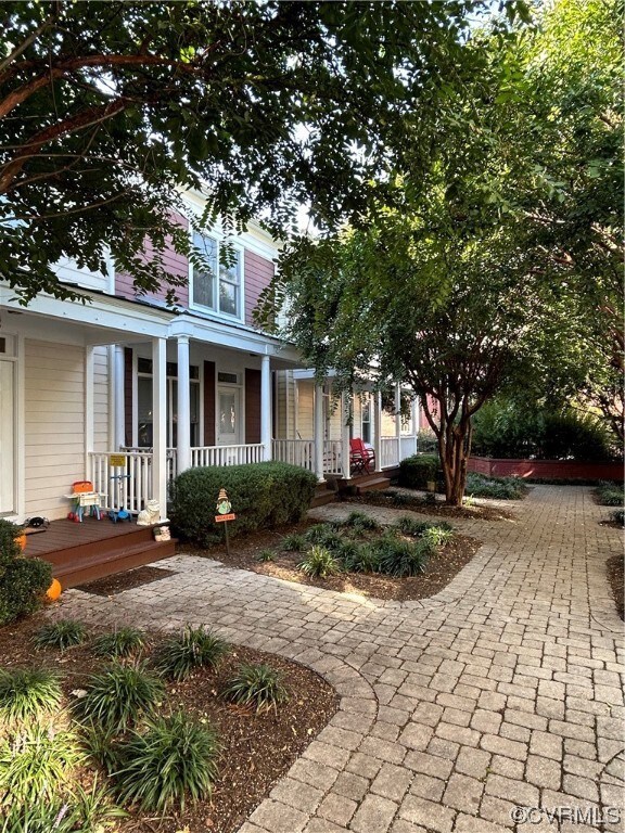 Shady cobblestone courtyard with front porch entra