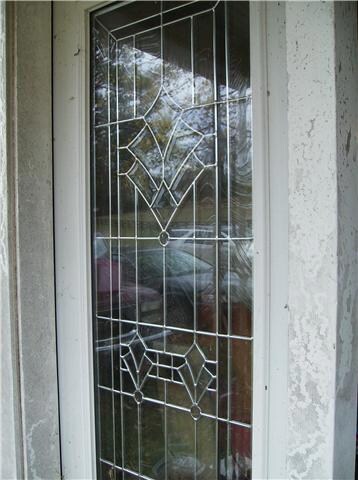 Leaded glass entry leads to 19x15 Living Room.  A fireplace in left rear corner. Beadboard ceilings, hardwood floors, just needs paint in front room to finish.