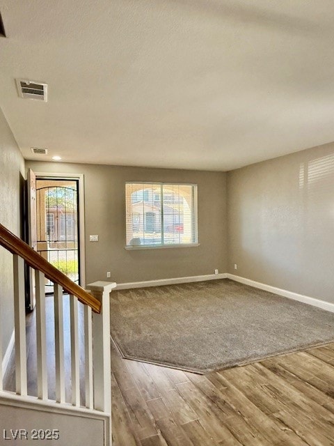 Foyer entrance with light wood-style flooring and baseboards