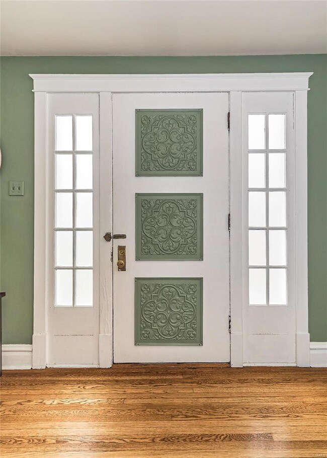 A view of the Entry System from the interior.  This is just a hint of the natural light that illuminates this residence.  Notice the period correct Cross head trim and base detail.