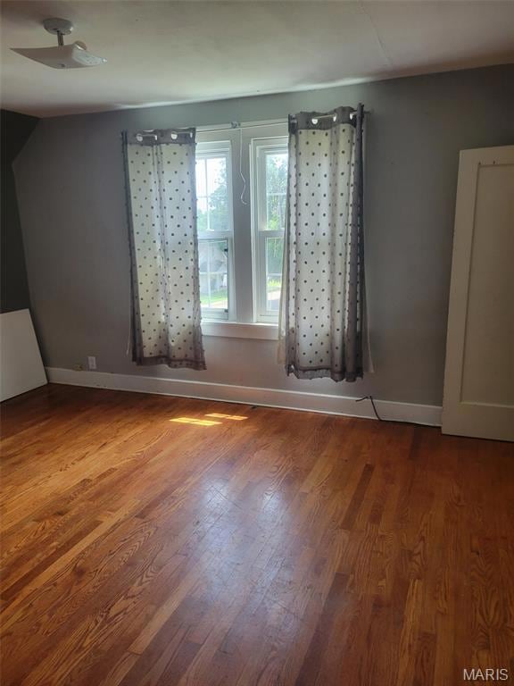 Empty room with wood finished floors and baseboards