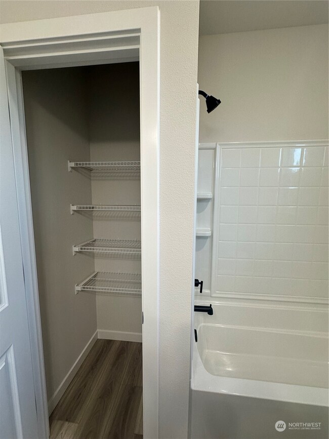 Linen closet in secondary bathroom Disclaimer: These photos are of another Aurora Home in community. Depictions of home, layout, location or other features, colors and color scheme, materials, fixtures, etc. are for showing purposes only and may not be included in the purchase price and availability may vary.