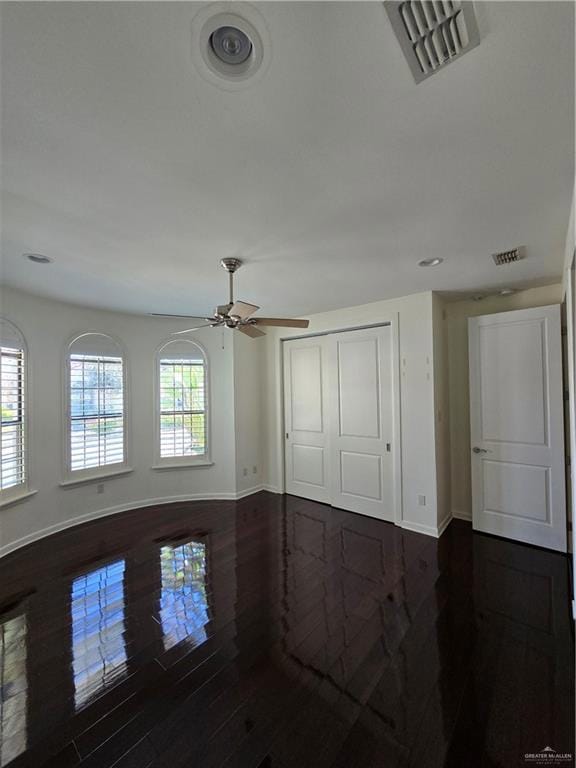 Spare room with dark wood-style floors, recessed lighting, and ceiling fan