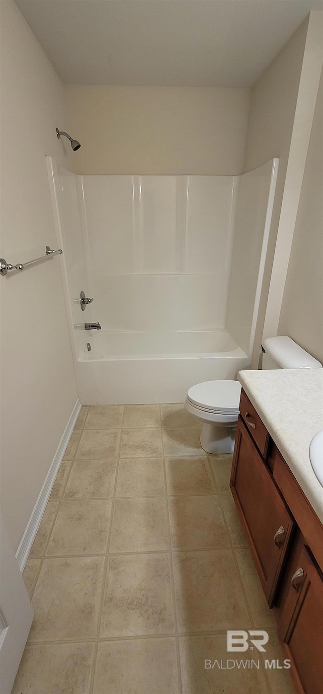 Bathroom featuring vanity, bathing tub / shower combination, and light tile patterned floors