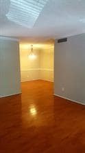 Empty room featuring wood finished floors