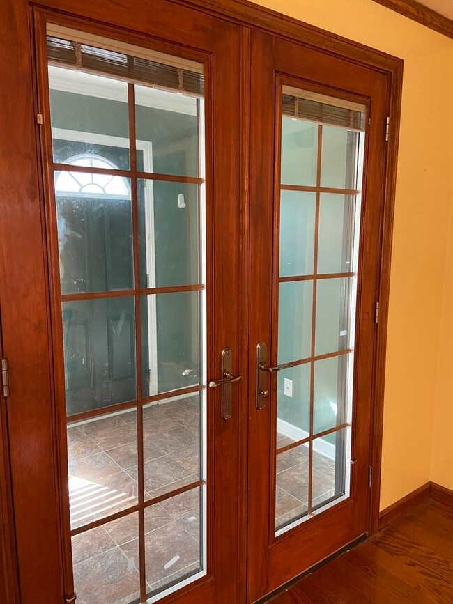 French doors to Foyer, off the dining room