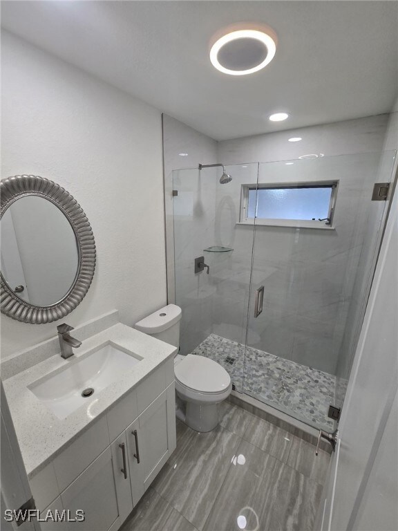 Bathroom with vanity and a shower stall