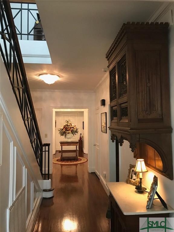Hallway facing front door featuring wrought iron r