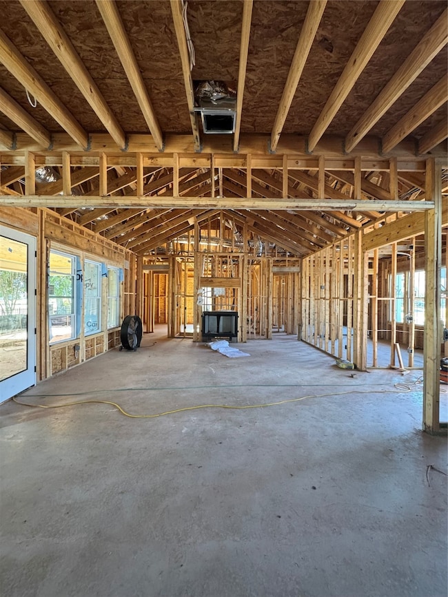 Miscellaneous room with concrete flooring and a garage