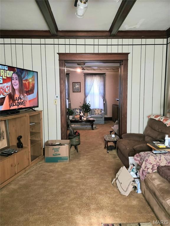 Carpeted living room with beam ceiling