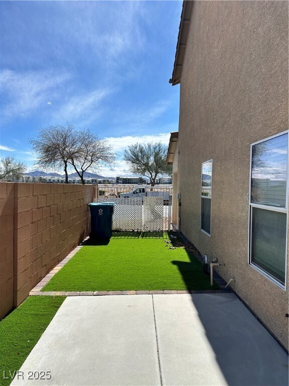 View of yard featuring a patio and fence