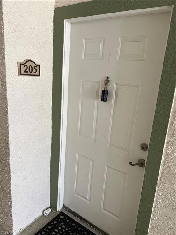 View of exterior entry with stucco siding