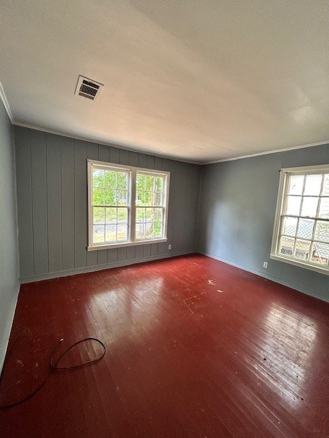 Unfurnished room featuring hardwood / wood-style flooring and ornamental molding