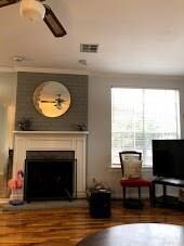 FIRE PLACE IN LIVING ROOM WITH WOOD LAMENT FLOORS