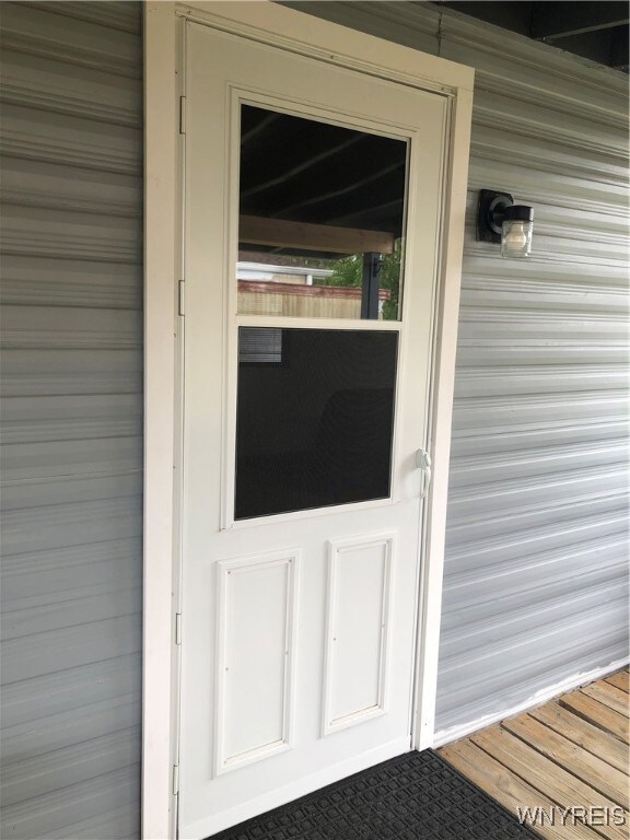 NEW SELF STORING STORM DOOR