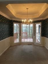Unfurnished dining area featuring a wainscoted wal