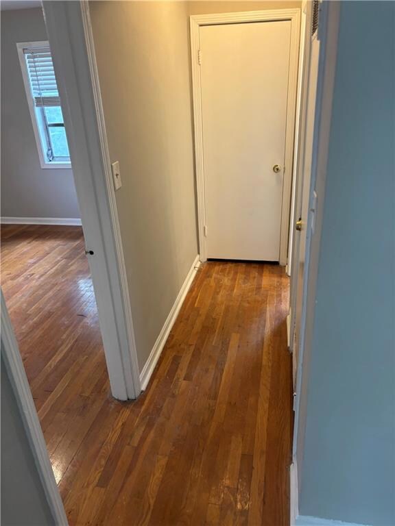 Hallway featuring dark wood-style flooring