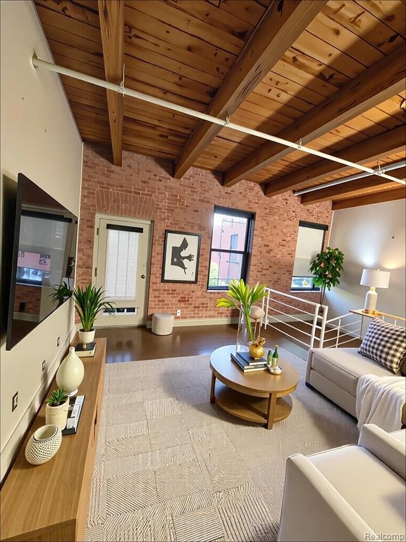Living room with brick wall, a wood ceiling with exposed beams, and wood finished floors