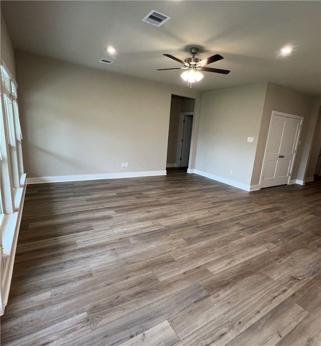 Empty room featuring wood finished floors, a ceili