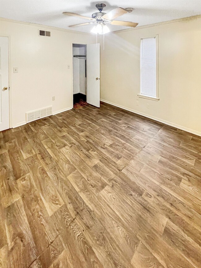 Empty room with baseboards, visible vents, a ceili