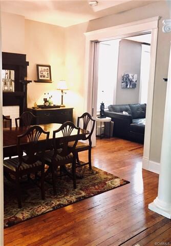 Dining Room with a nice arched entry with column, fireplace and pocket doors to living room.