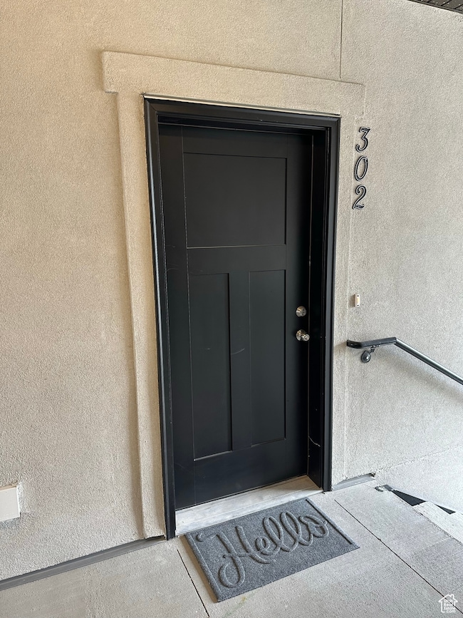 Property entrance with stucco siding