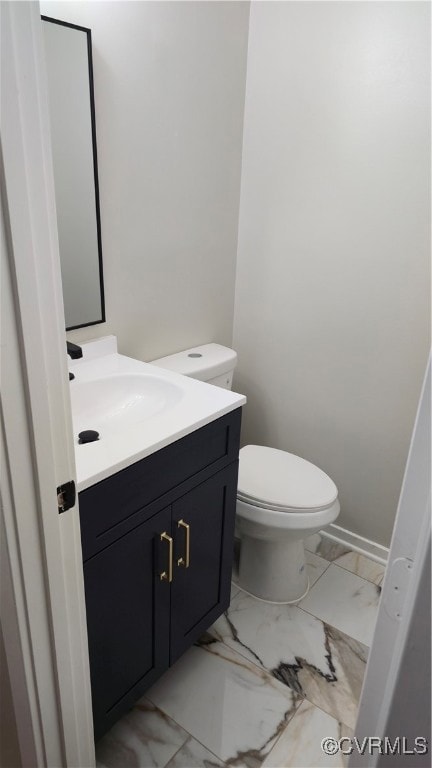 Bathroom featuring vanity, marble finish floors, t