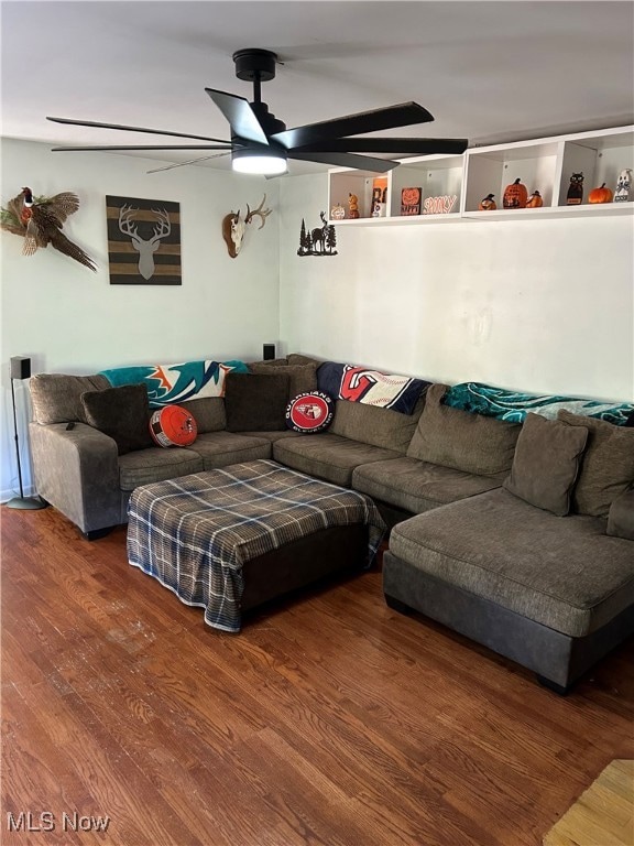 Living room featuring wood finished floors and a ceiling fan