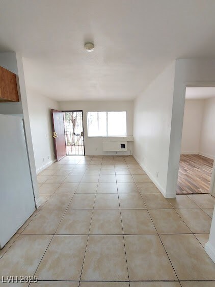 Spare room featuring light tile patterned floors,