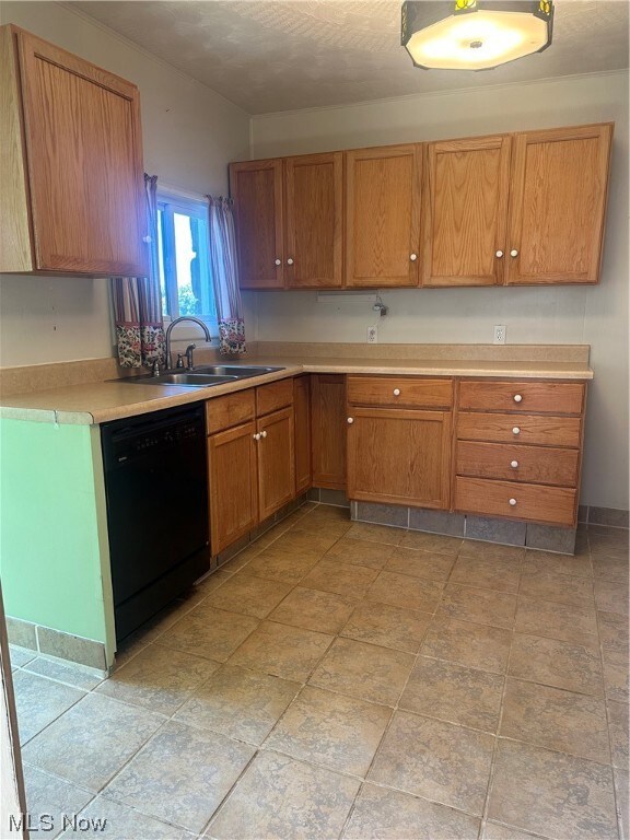 Kitchen with sink, light tile flooring, and dishwasher