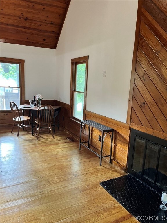 Dining space with wood-type flooring, vaulted ceil