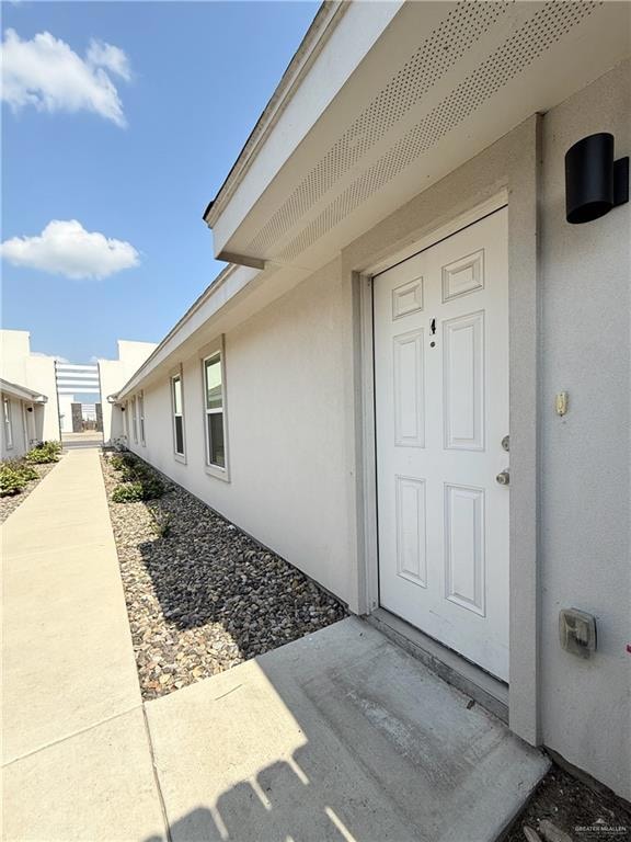 Property entrance with stucco siding