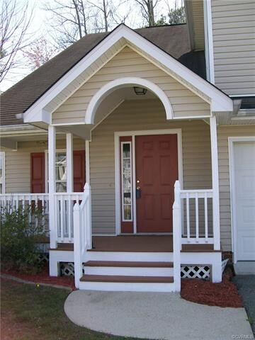 Welcome Home! Covered front porch with arched entry.
