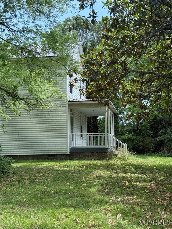 View of home's exterior with a lawn, crawl space,