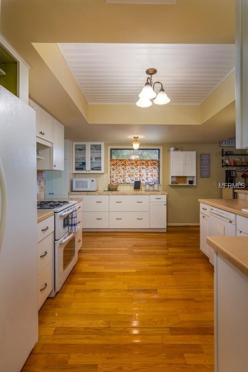 This updated kitchen has Corian countertops & draw