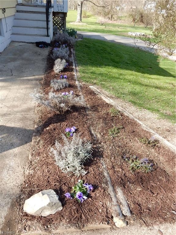 Fresh flowers and aromatic lavender line the walk-