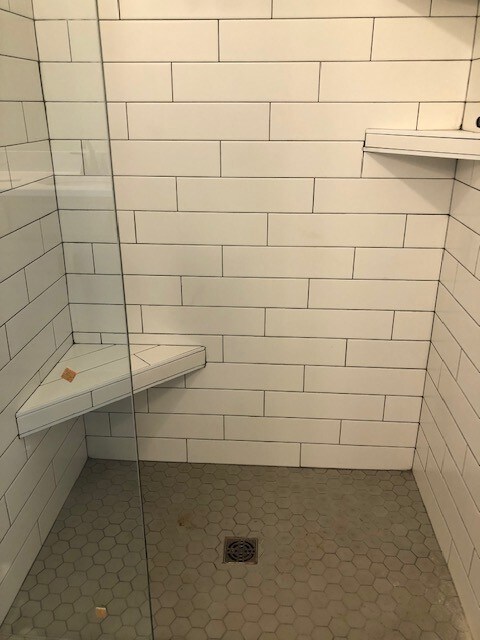 Subway tiled Master shower w/ corner seat and shelf.