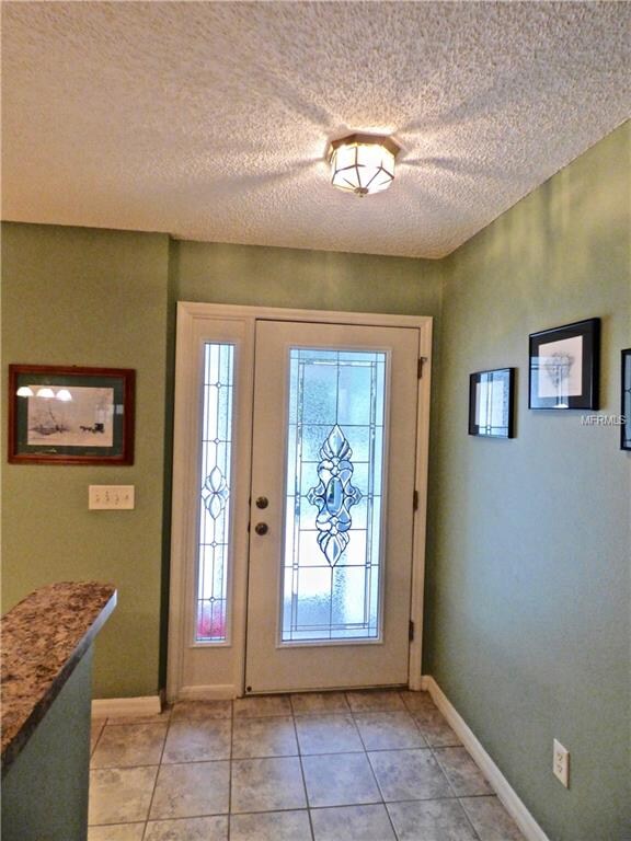 Tiled Entry with Beautiful Leaded-Glass Door and S
