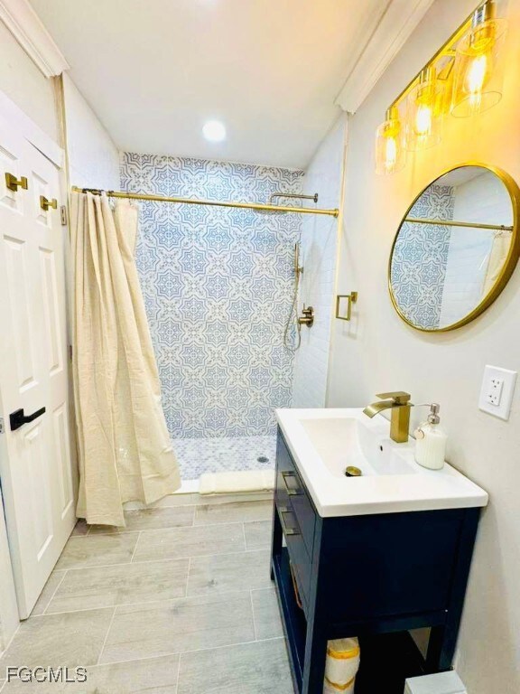 Bathroom featuring a shower stall and vanity