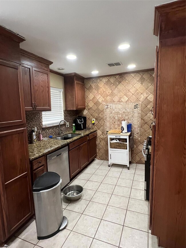 Kitchen with visible vents, light tile patterned f